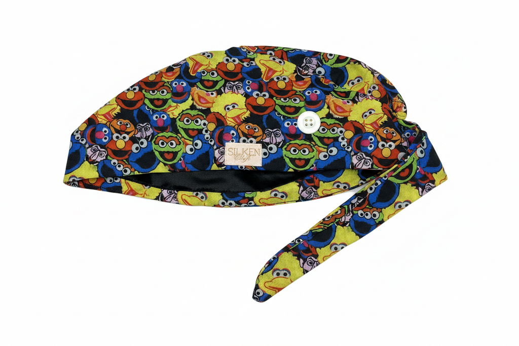 Sesame Street scrub cap side view with silky black lining and button loop