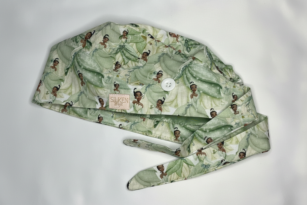 Princess Tiana scrub cap angled view showing button loop and tie-back