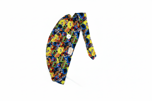 Sesame Street scrub cap flat lay showing tie-back and full print